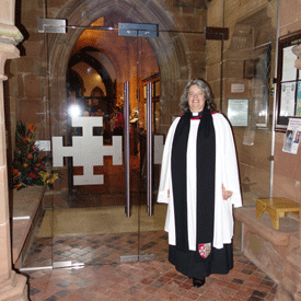 The Archdeacon in front of the new glass doors